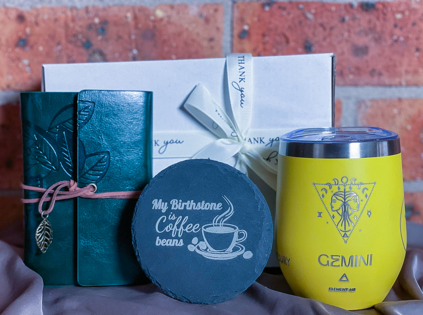 Personalised gift set with blue engraved astrology tumbler-blue turquoise faux-leather travel journal engraved and engraved slate coaster.