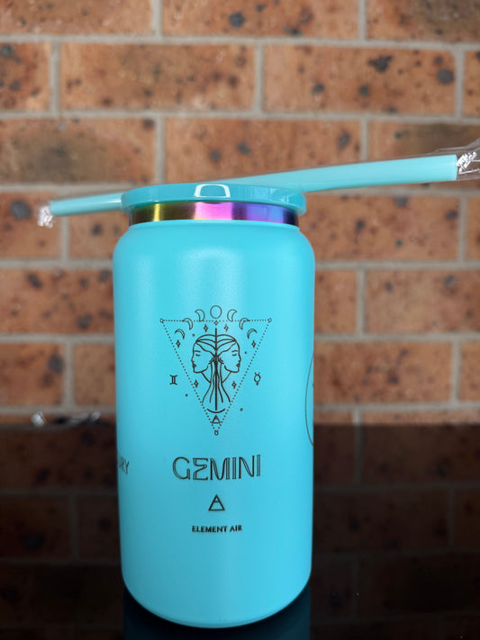 A light blue insulated tumbler with a matching straw, featuring a Gemini zodiac design and text, resting on a brown brick surface. Gemini tumbler, Gemini birthday gift, engraved zodiac tumbler, turquoise insulated mug, astrology gifts, personalized tumbler.